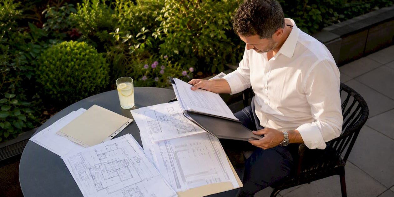 1785704002110_Business-owner-reviewing-refurbishment-plans Business owner reviewing refurbishment plans