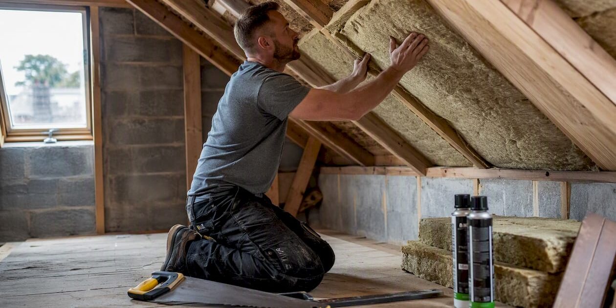 1785824666511_Builder-fitting-roof-insulation-in-loft Builder fitting roof insulation in loft