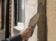 Close-up of UK house walls with varied render finishes
