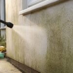 Soft-washing rendered wall in Liverpool home